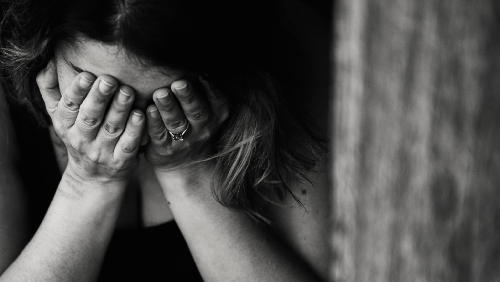 woman-face-in-hands-grief