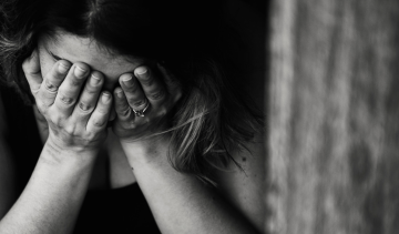 woman-face-in-hands-grief