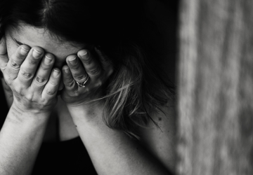 woman-face-in-hands-grief